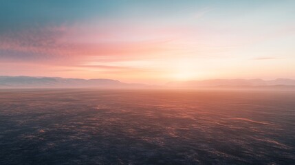 Fototapeta premium Vast landscape view with mountains in the distance during a colorful sunset
