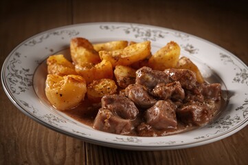 Beef Stroganoff served with crispy fried potatoes on a unique dish