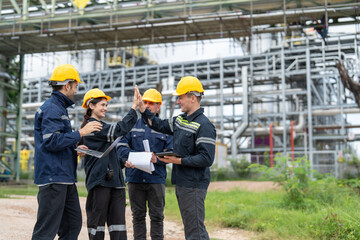 Diverse group of petrochemical engineers high-five to work success inspection and maintenance plans...