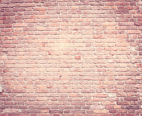 The background is a red brick texture