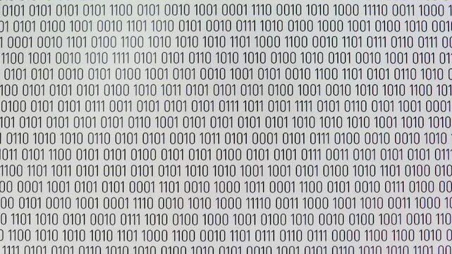 Black binary code moving down on a white background. A large number of black ones and zeros, symbolizing binary code, move down on a white computer screen