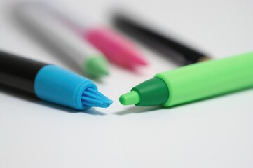 Isolated blue and green markers on a white surface