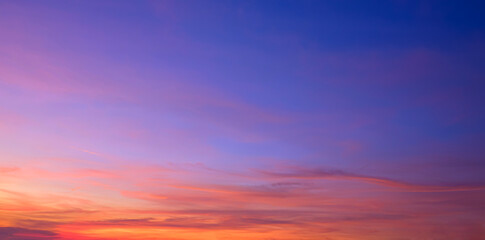Twilight sky background with natural light and colorful orange sunlight cloud on blue evening sky in panoramic view