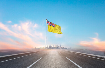 Niue national flag with mast waving with beautiful skyline. A view from highway. Niue national flag...