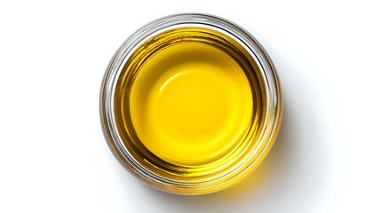Fresh golden olive oil or cooking oil in round glass bowl viewed from above on white background, isolated transparent liquid for culinary and cosmetic use.