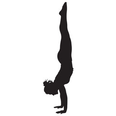 Fototapeta premium Strong Woman Silhouette Performing a Handstand Pose