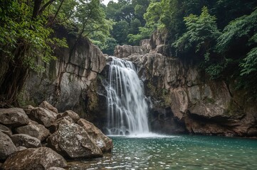 Fototapeta premium Stunning cascade surrounded by lush green woodland and rocky terrain