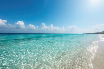 Serene coastal view featuring water, sky, and sandy shore with summer vibes