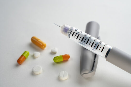 Semaglutide treatment concept with pills and injection pen