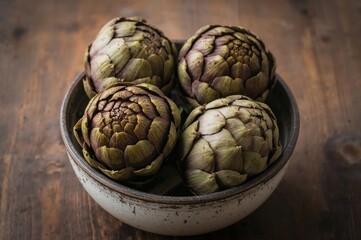 Obraz premium A rustic bowl filled with artichokes on a wooden table highlights their distinctive forms and natural hues, capturing the spirit of thoughtful culinary tradition.