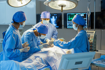 A group of surgeons are performing a surgery on a patient. Scene is serious and focused, as the surgeons are working together to save the patient's life.