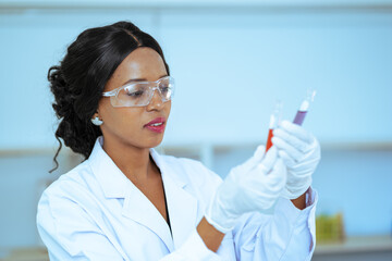 Scientist in laboratory with holding a test tube. Medical healthcare technology and pharmaceutical research and development concept