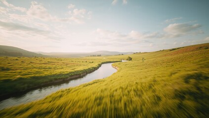 Fototapeta premium A river flowing through a lush green meadow in the countryside
