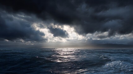 Fototapeta premium Dramatic seascape showcasing a stormy sky with light piercing through dark clouds over a rippling ocean.