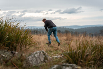 Fototapeta premium regenerative organic farmer, taking soil samples and looking at plant growth in a farm. practicing sustainable agriculture good looking farmer