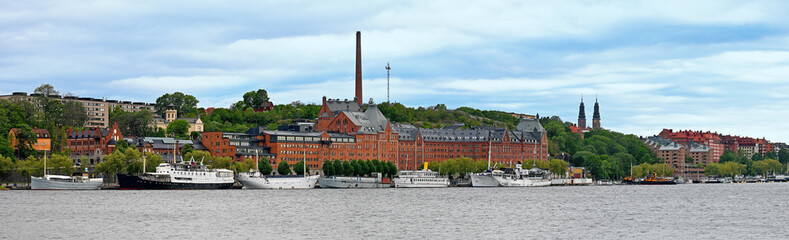 Panorama of S&ouml;dermalm on the south shore of Riddarfj&auml;rden with buildings of the former M&uuml;nchenbryggeriet and ships at the quay in Stockholm, Sweden