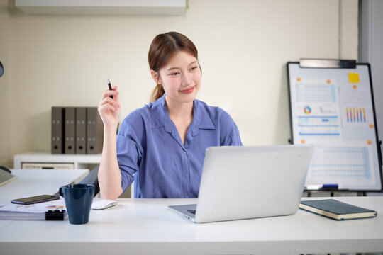 Businesswoman smiling during online meeting or video call at workplace.
