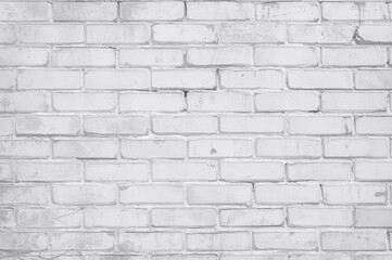Obraz premium Vintage white and light gray brick wall showcasing a distressed and worn texture