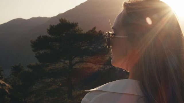 woman walking. travel around Europe. landscape mountains nature of Andorra. traveler girl climbing rocks at sunset summer. panoramic aerial view from drone above entire city capital Andorra la Vella