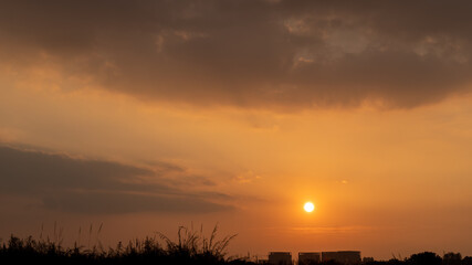 The setting sun, its afterglow, and the natural scenery