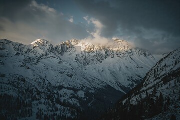 Breathtaking panorama of sunlit snowy mountains showcasing a striking and scenic landscape with a nostalgic vintage Instagram filter effect