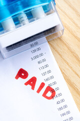 Closeup of Paid Stamp on Business Invoice Paperwork
