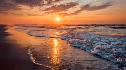 Naklejka premium A breathtaking sunrise paints the ocean shoreline with warm hues, showcasing the tranquil beauty of a coastal scene.