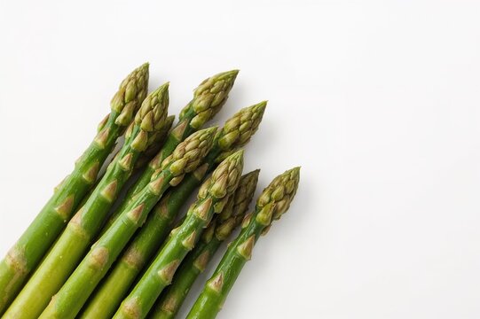 Detailed view of fresh green asparagus against a clean white backdrop, isolated, natural, springtime, dining, health, green vegetables
