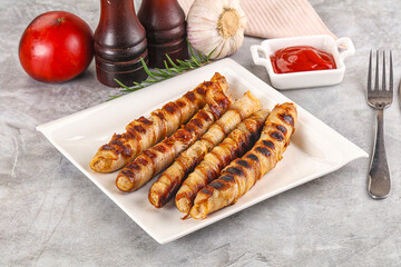 Grilled meat sausages wrapped bacon