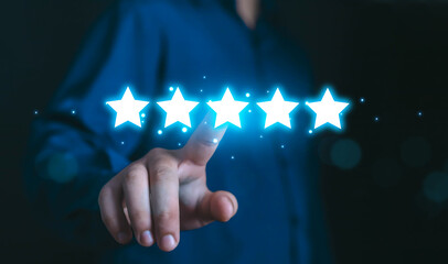 Hand touching glowing five stars rating symbol. Concept of customer satisfaction, excellent review, rating, online feedback, trusted service, digital reputation, and positive experience interactions