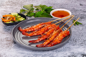 Grilled prawn skewer served sauce