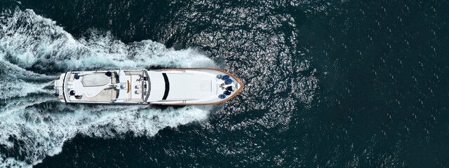 Aerial drone ultra wide tracking photo with copy space of beautiful modern super yacht with wooden...