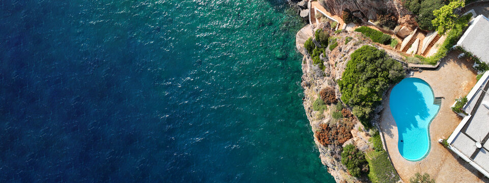 Aerial drone top view ultra wide photo of luxury tropical villa with large pool located in mediterranean destination