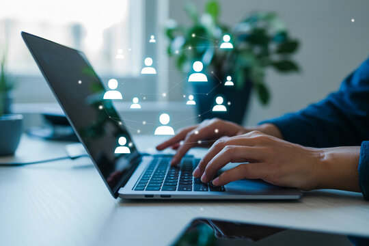 Connecting People Online A Person Typing on a Laptop with Network Icons Illustrating Digital Communication