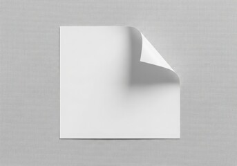 Blank white paper with a curled corner on a textured gray background