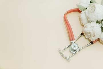 Medical Instruments with flowers on yellow Background. photo of a medical hammer, orchidometer,...