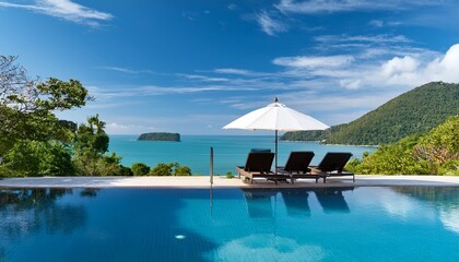 Obraz na płótnie Canvas white umbrella and lounge chairs by the infinity pool looking over the island ocean view in thailand