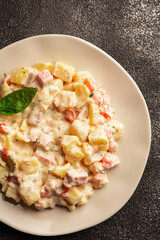 Potato salad ham, potato, tomato, carrot, mayonnaise tasty snack fresh delicious gourmet food background on the table rustic top view copy space