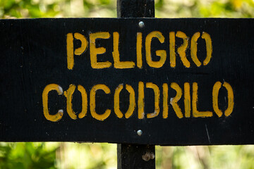 Sign in Cahuita National Park that translates into English as Danger: Crocodiles in Costa Rica
