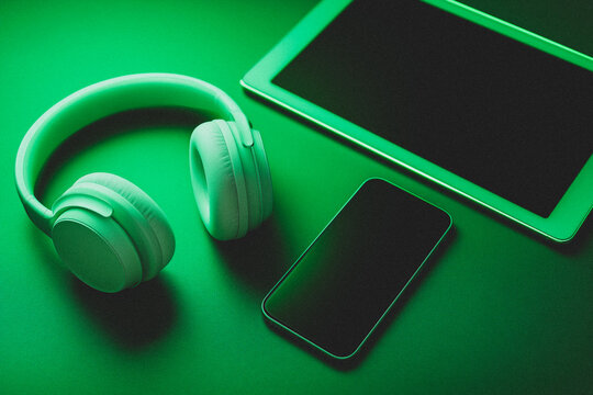 Grainy textured green overlay background with wireless devices on the table