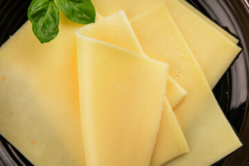 Gouda cheese slices hard cheese variety natural product tasty snack fresh delicious gourmet food background on the table rustic top view copy space