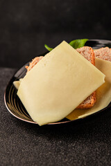 Gouda cheese slices hard cheese variety natural product tasty snack fresh delicious gourmet food background on the table rustic top view copy space