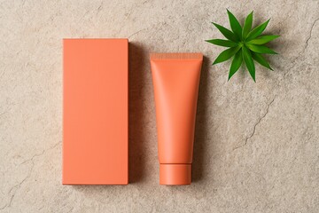Cosmetic cream tube with box and plant on stone background