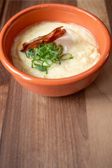 Cozy kitchen with a creamy breakfast bowl and poached egg