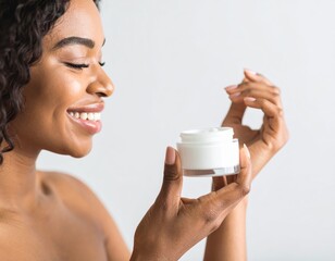 Smiling African woman holds a jar of face cream, looking at it with a happy expression.