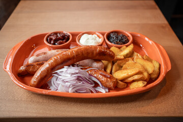Delicious platter of sausages and potatoes enjoyed at a cozy eatery