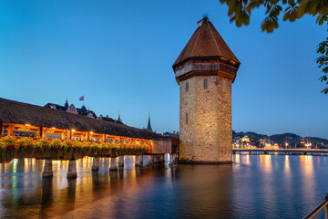 Lucerne, Switzerland. View of Water Tower (Wasserturm) and Chapel Bridge (Kapellbrucke) at dusk