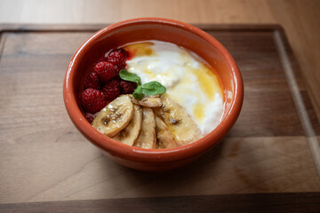 Yogurt with bananas and raspberries makes a delightful breakfast