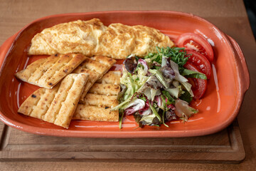 Delicious breakfast platter featuring fluffy omelette and fresh vegetables