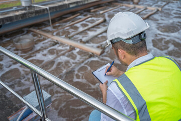 Engineer inspecting wastewater treatment process at a facility. Professional quality control and...